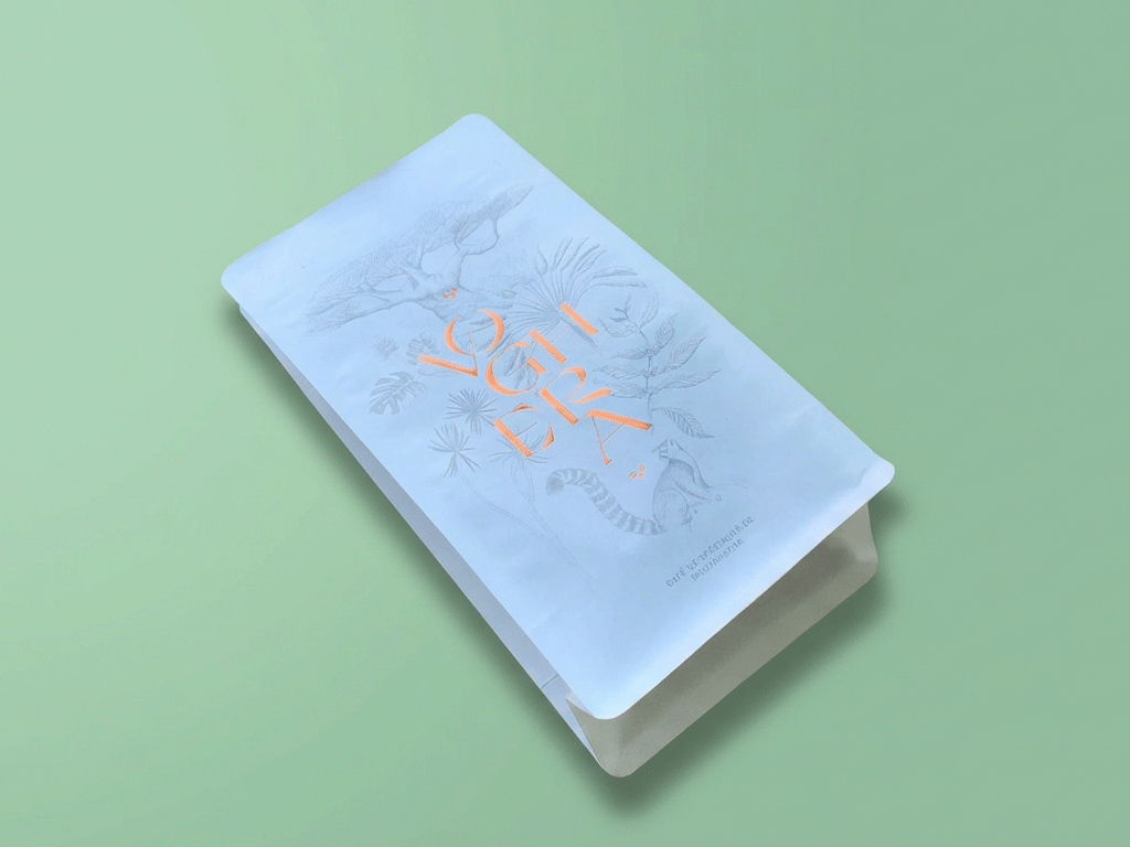 Coffee bag with botanical illustration and orange lettering, featuring white kraft paper packaging.