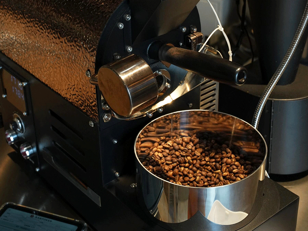 roasted coffee beans in a roaster ready for grinding