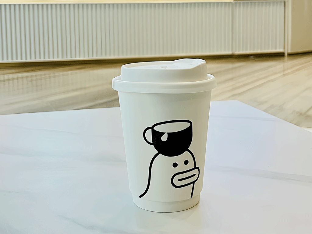 Paper coffee cup on a wooden table.