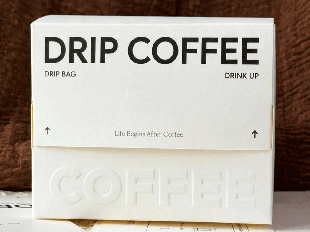 Embossing coffee box with bold raised artwork and clean design on a brown textured table.