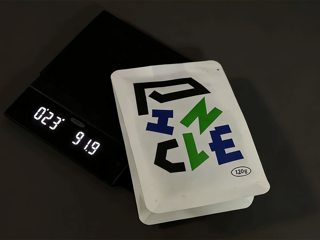 Top-down view of a coffee bag placed on a dark surface.