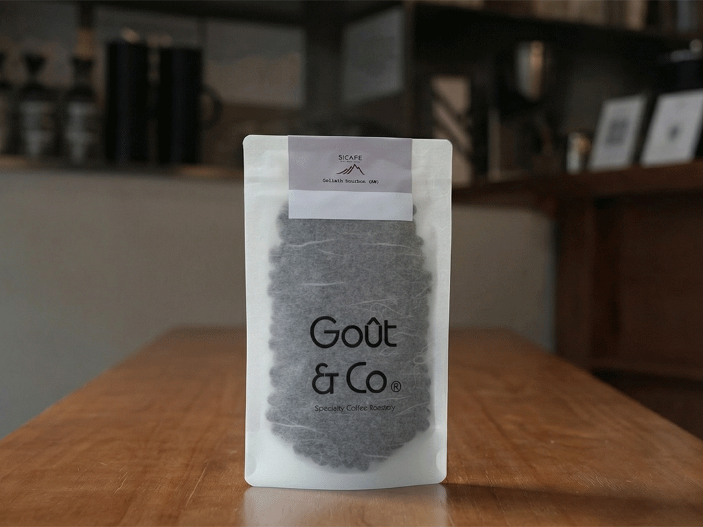 Custom label applied to a rice paper coffee bag with visible roasted coffee beans
