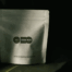 stand-up coffee packaging bag displayed in low light studio setting