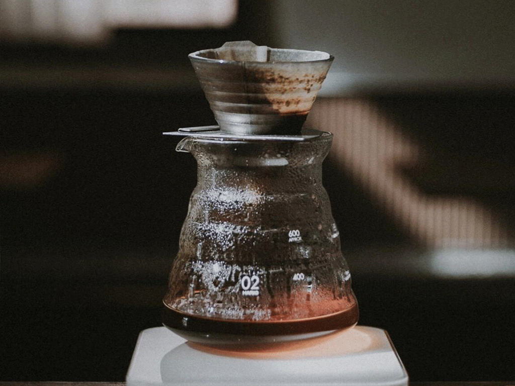 What_Is_Specialty_Coffee_and_Why_It_Matters_1 specialty coffee pour over brewing in a glass dripper and server