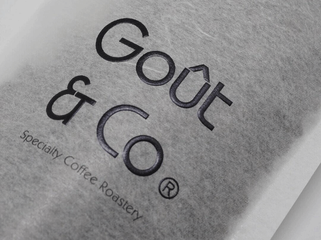 Close-up of a rice paper coffee bag showing embossed logo and textured surface