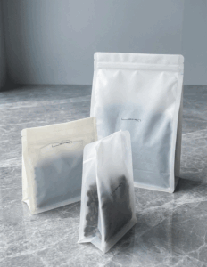 Three coffee bags in different sizes displayed on a marble surface