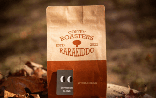 Kraft paper coffee bag with espresso blend label displayed outdoors among autumn leaves
