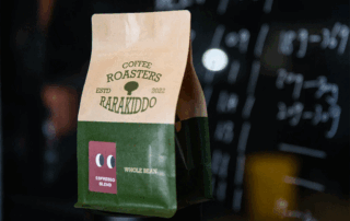 Specialty coffee packaging with a kraft paper flat bottom coffee bag in a coffee shop setting