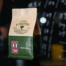 Specialty coffee packaging with a kraft paper flat bottom coffee bag in a coffee shop setting