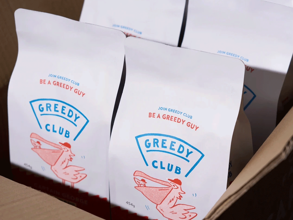 Custom coffee bags packed in a cardboard shipping box for roasted coffee delivery