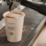 Takeaway coffee cup being filled with espresso from a commercial coffee machine