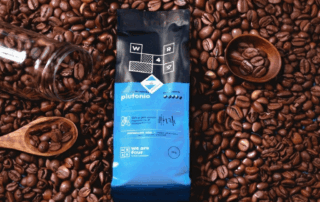 Premium printed custom coffee bag manufacturer product surrounded by fresh beans