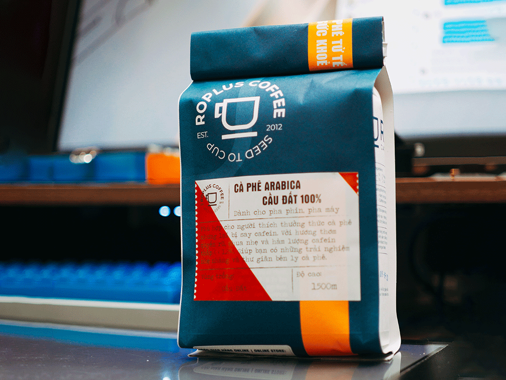Custom printed coffee bag manufacturer pouch displayed in a roastery workspace