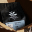 Black coffee bag with origin label for a coffee packaging redesign