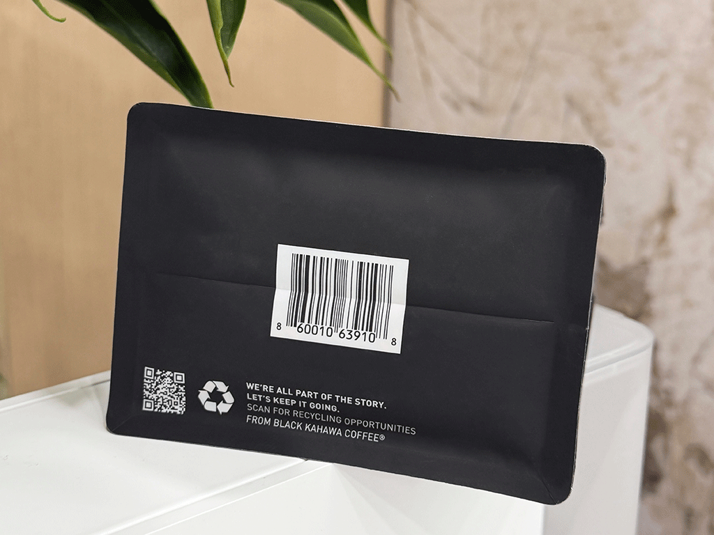Bottom view of a sustainable coffee bag showing a barcode and recycling instructions