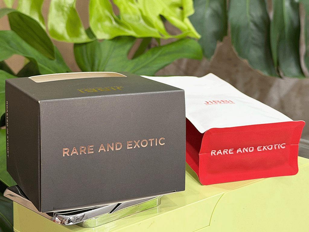 Coffee box with gold hot foil stamping details alongside a matching coffee bag packaging
