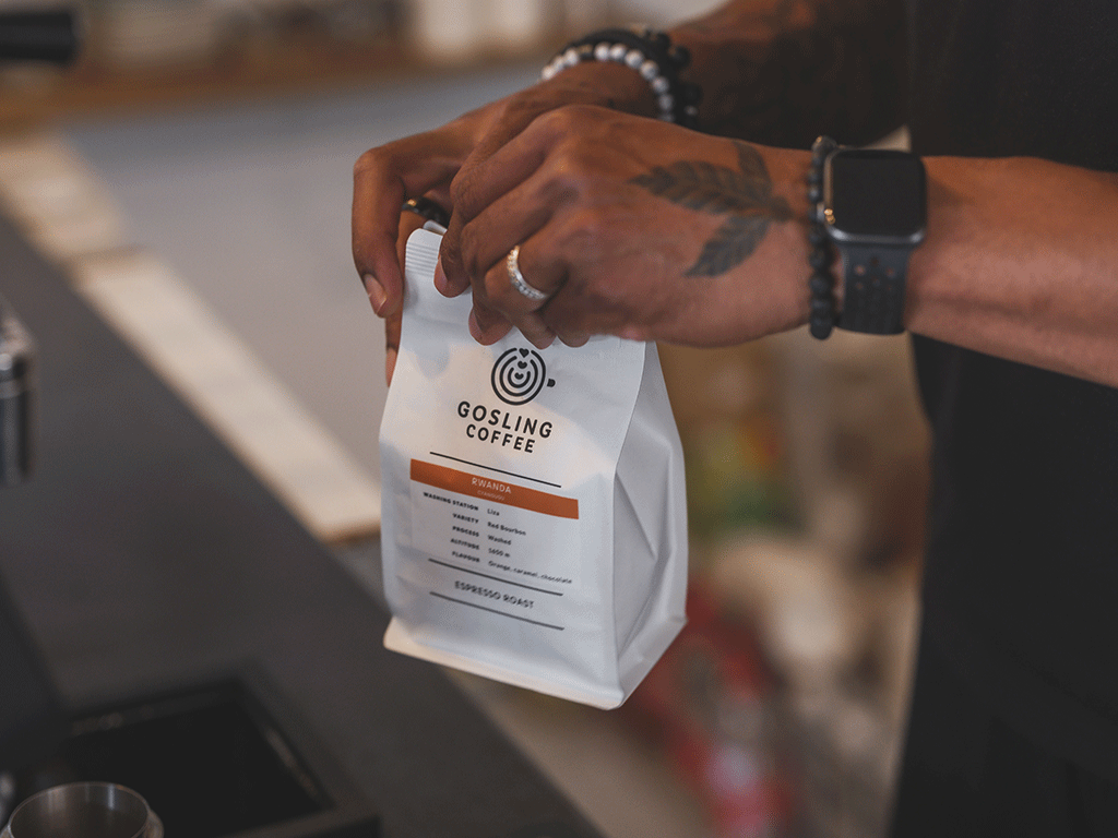 Hand holding a custom coffee bag showing specialty coffee packaging design and branding
