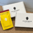 Yellow coffee bag placed beside two white coffee subscription boxes