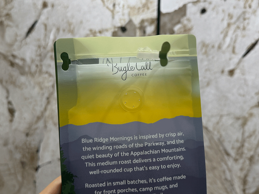 coffee bag being opened by pulling the resealable zipper for convenient access